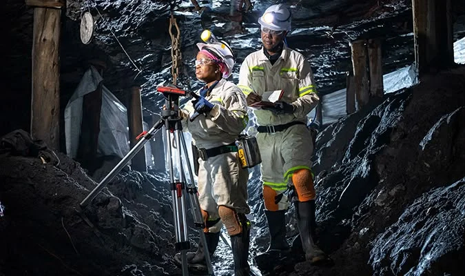 Underground survey team taking measurements